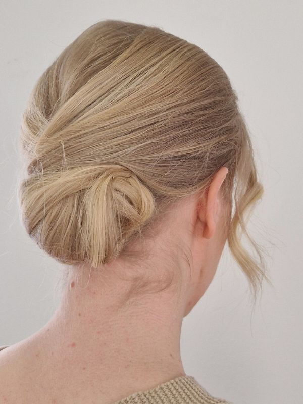 Elegant low bun created by Hair Studio Niki Newd® — a timeless, sophisticated updo with smooth lines and refined balance for formal events.